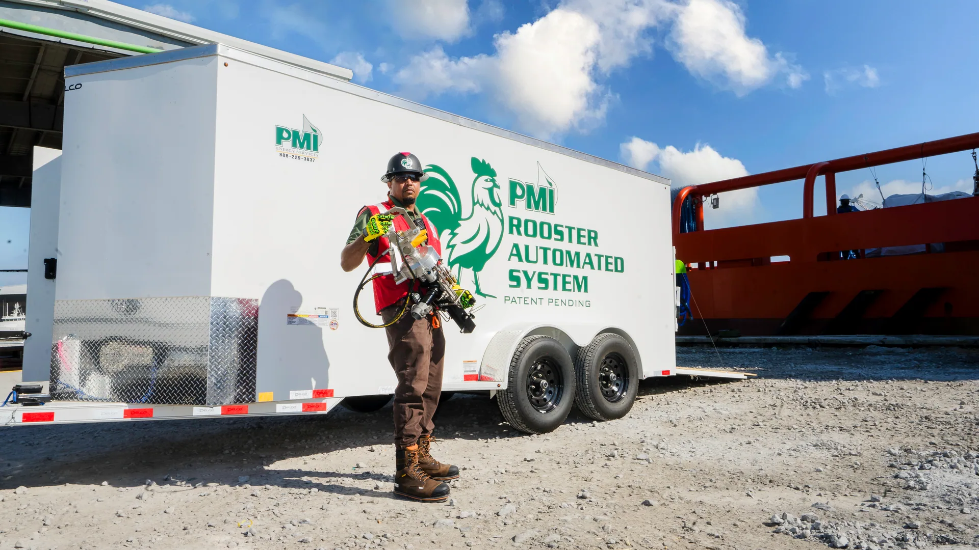 Operator working beside the RoosterEX automated tank cleaning trailer